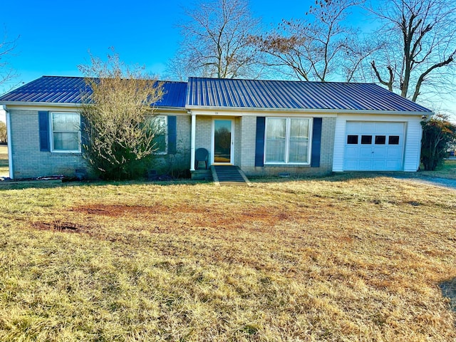 ranch-style house featuring a garage and a front yard