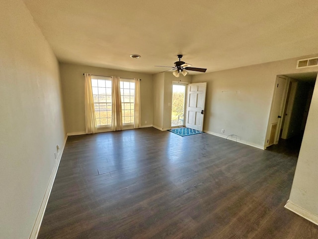 spare room featuring dark hardwood / wood-style floors and ceiling fan