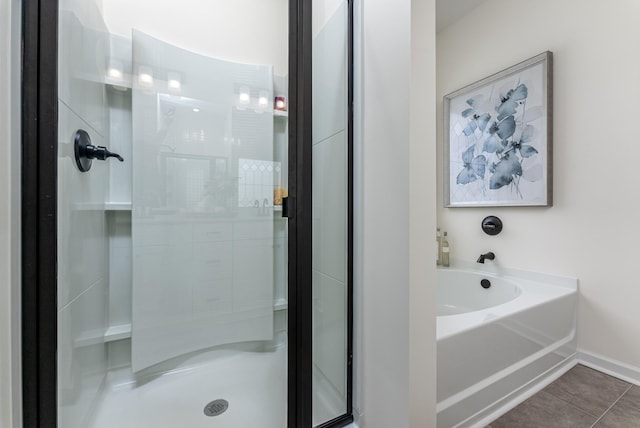 bathroom featuring tile patterned floors and independent shower and bath