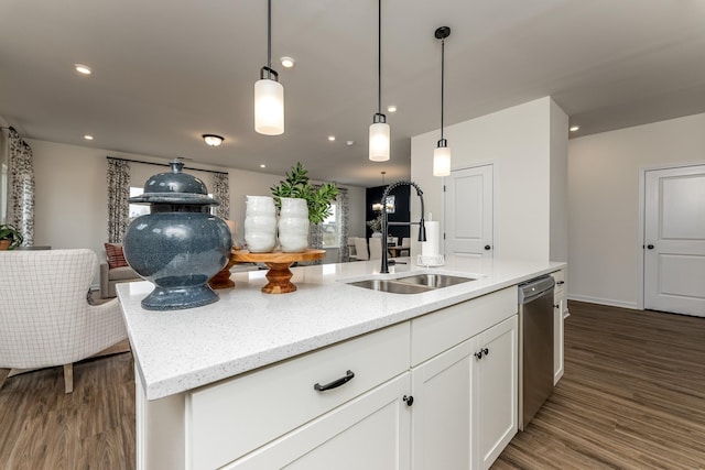 kitchen featuring white cabinetry, an island with sink, dishwasher, sink, and light stone countertops