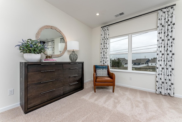 living area featuring light carpet and vaulted ceiling