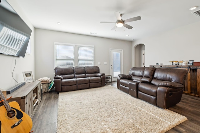 living room featuring ceiling fan and dark hardwood / wood-style flooring