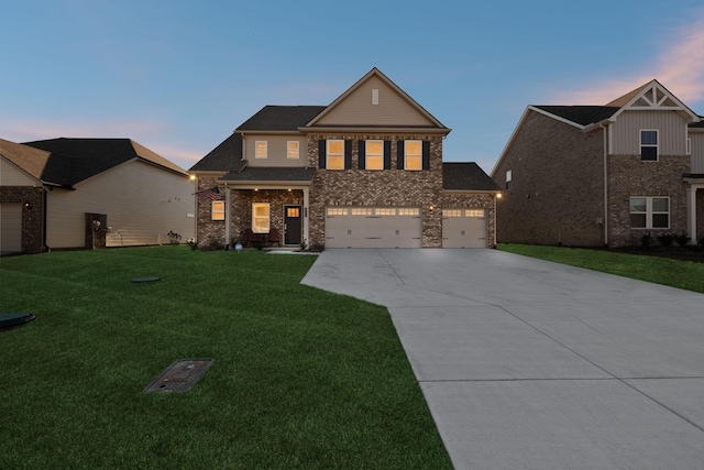 view of front of property featuring a garage and a lawn