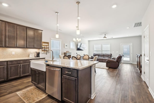 kitchen featuring stainless steel dishwasher, dark brown cabinets, sink, and a center island with sink