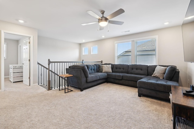 carpeted living room featuring ceiling fan