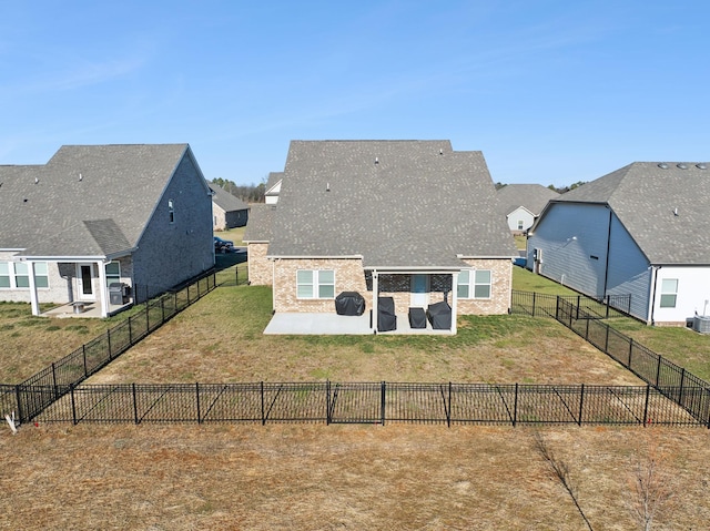 rear view of property with a yard and a patio area