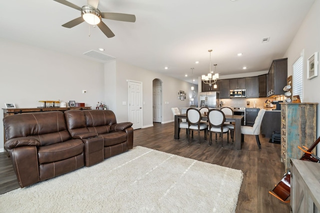 living room featuring dark hardwood / wood-style floors and ceiling fan with notable chandelier