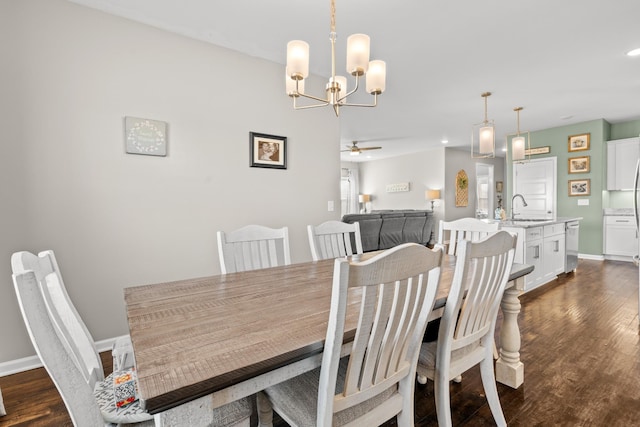 dining space with sink, dark wood-type flooring, and ceiling fan