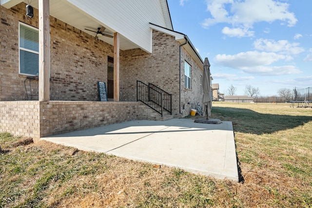 view of side of home with a lawn and a patio