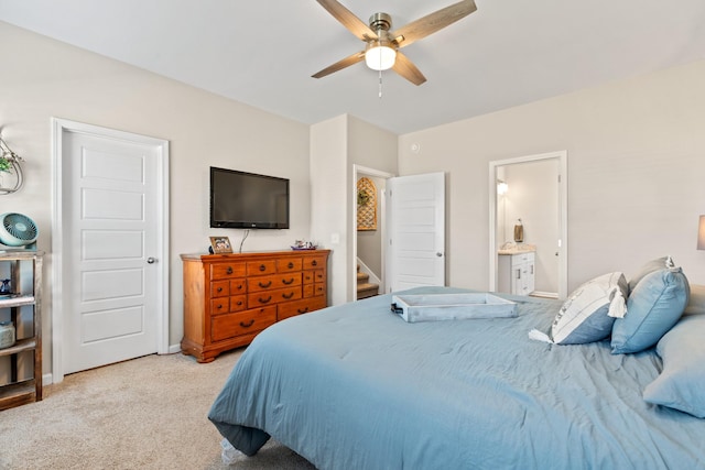 carpeted bedroom featuring ceiling fan and connected bathroom