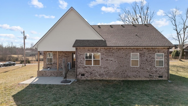 back of house with a patio area and a lawn