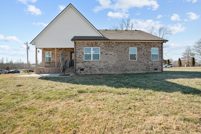 rear view of property with a yard