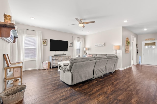 living room featuring dark hardwood / wood-style floors and ceiling fan