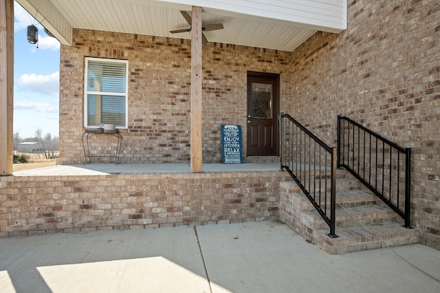 view of exterior entry with a patio area