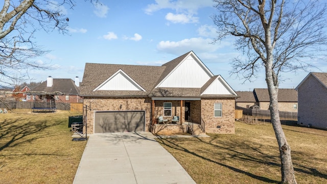 view of front of home with a garage, a trampoline, and a front yard