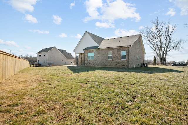 rear view of house with a yard