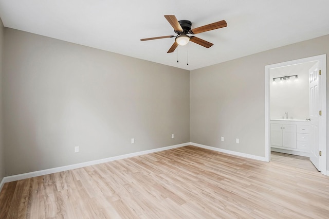 unfurnished bedroom with ceiling fan, light wood-type flooring, and ensuite bath