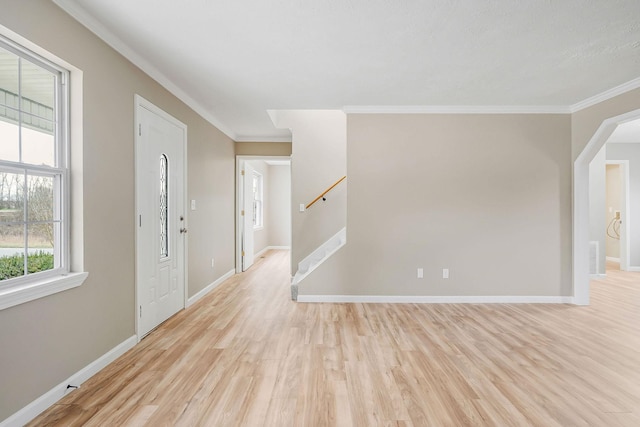 entrance foyer featuring crown molding and light hardwood / wood-style flooring