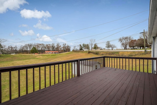 wooden terrace featuring a lawn