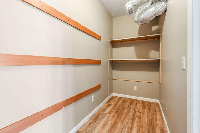 walk in closet featuring light hardwood / wood-style floors