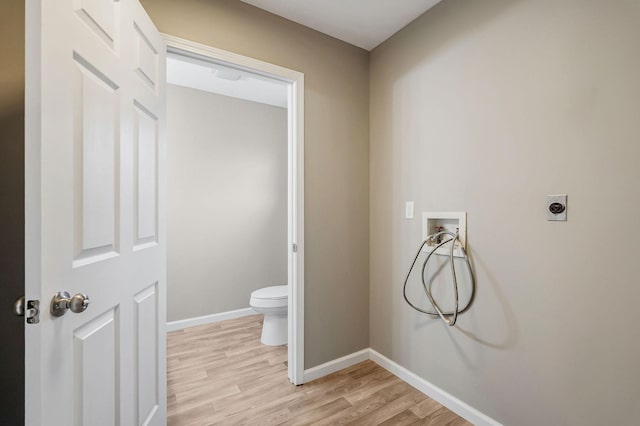 bathroom with hardwood / wood-style flooring and toilet