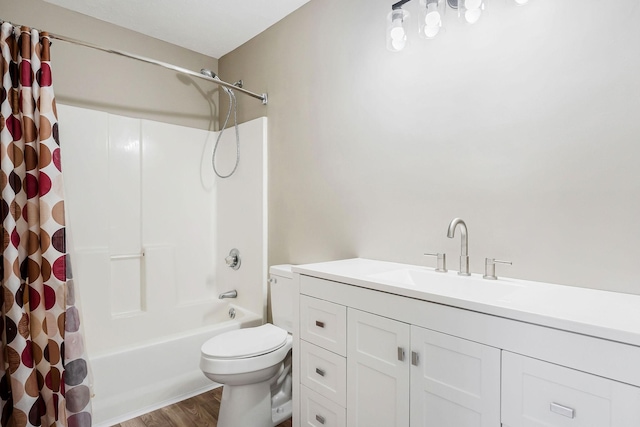 full bathroom featuring toilet, hardwood / wood-style floors, vanity, and shower / bath combo with shower curtain