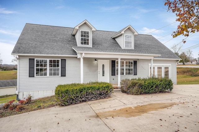 cape cod house featuring a porch