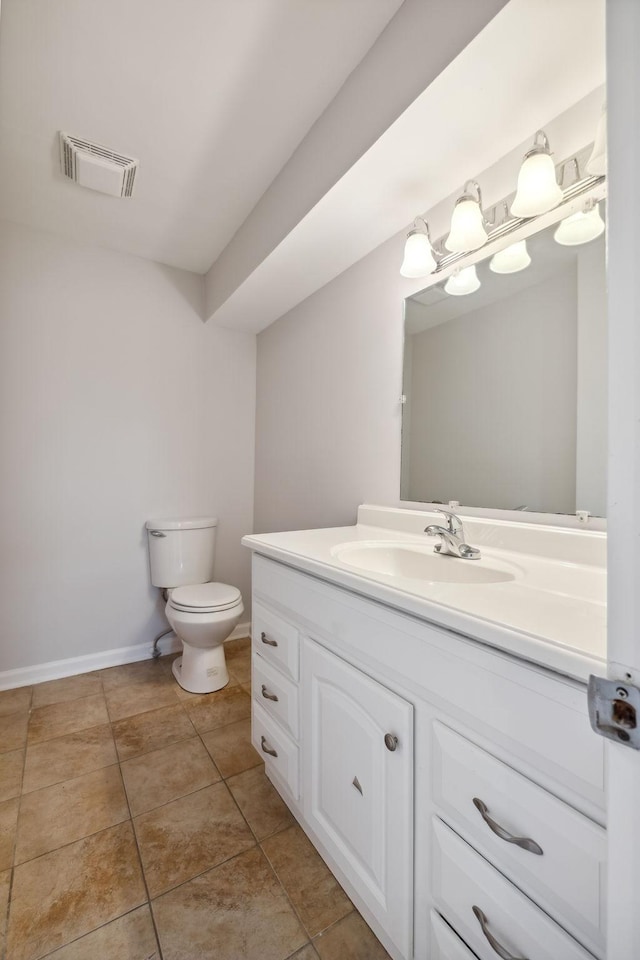 bathroom with vanity, tile patterned flooring, and toilet