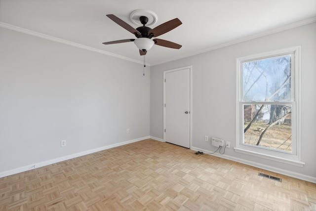 empty room featuring light parquet floors, ornamental molding, and a healthy amount of sunlight