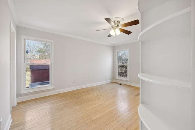 empty room with crown molding, ceiling fan, and light wood-type flooring