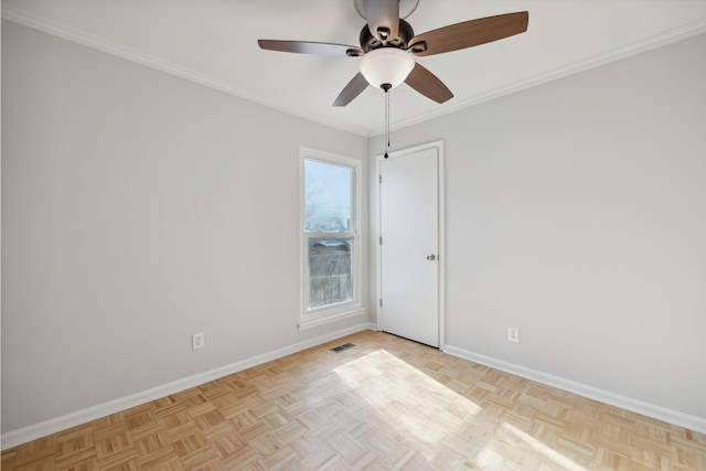 empty room featuring ceiling fan, crown molding, and light parquet floors