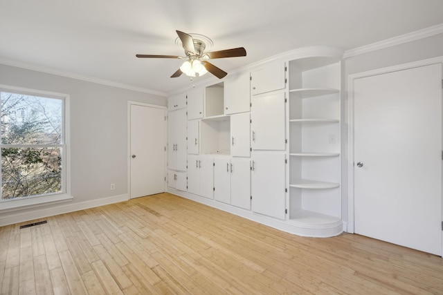 unfurnished bedroom featuring ornamental molding, ceiling fan, and light hardwood / wood-style flooring