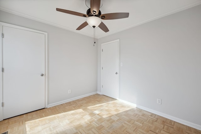 empty room with crown molding, ceiling fan, and light parquet flooring