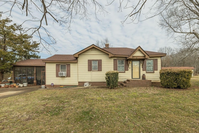 view of front of property with cooling unit, a front yard, and a sunroom