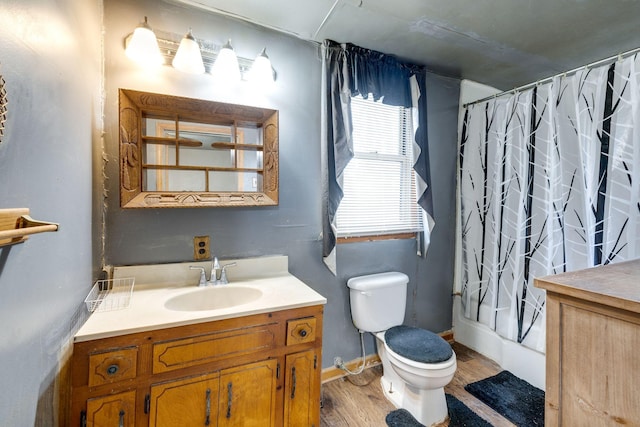 bathroom with walk in shower, wood-type flooring, toilet, and vanity