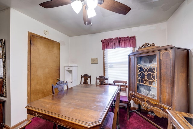 dining space with dark colored carpet and ceiling fan