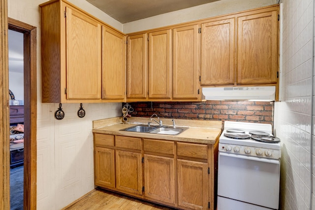 kitchen with sink, white electric range, and light hardwood / wood-style floors