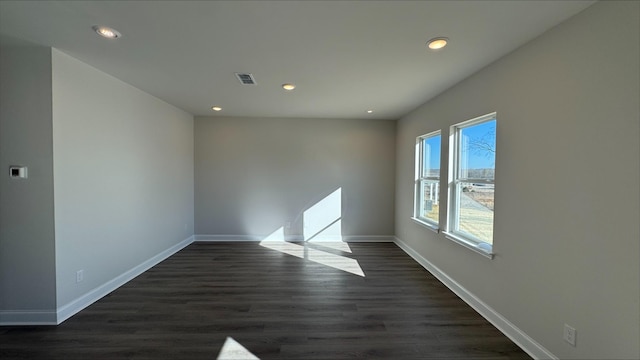 empty room with dark wood-type flooring