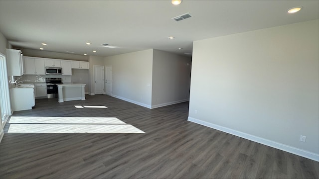 unfurnished living room with dark hardwood / wood-style floors and sink