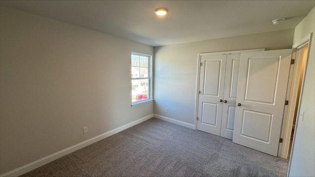 unfurnished bedroom featuring a closet and carpet flooring