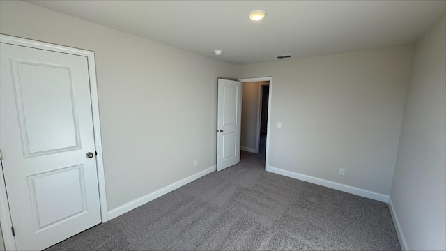 unfurnished bedroom featuring dark colored carpet