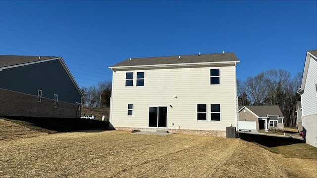 back of house featuring central AC and a lawn