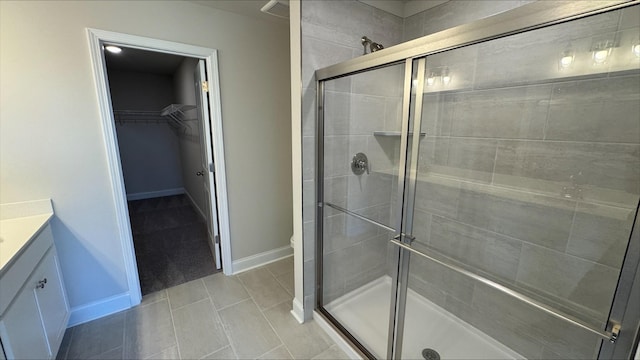 bathroom with vanity, tile patterned floors, and a shower with shower door