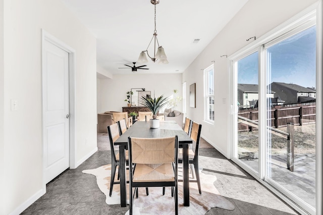 dining room featuring ceiling fan and tile patterned flooring