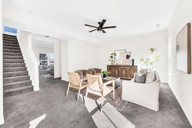 carpeted living room with ceiling fan