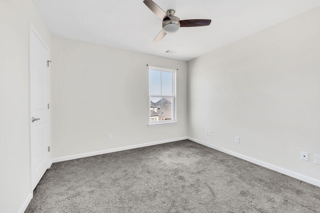 carpeted spare room featuring ceiling fan