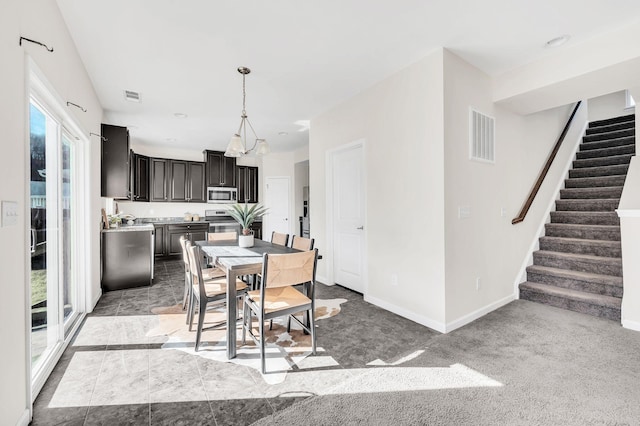 dining room with a healthy amount of sunlight and light carpet