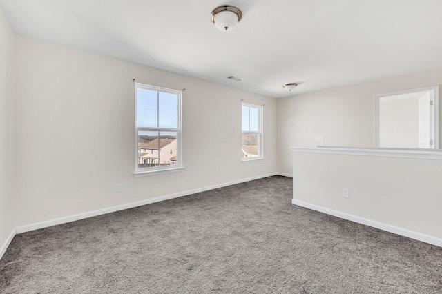 unfurnished room featuring dark carpet