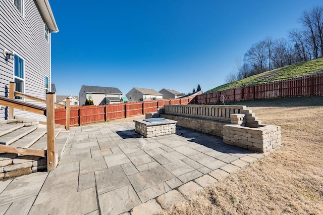 view of patio with a fire pit