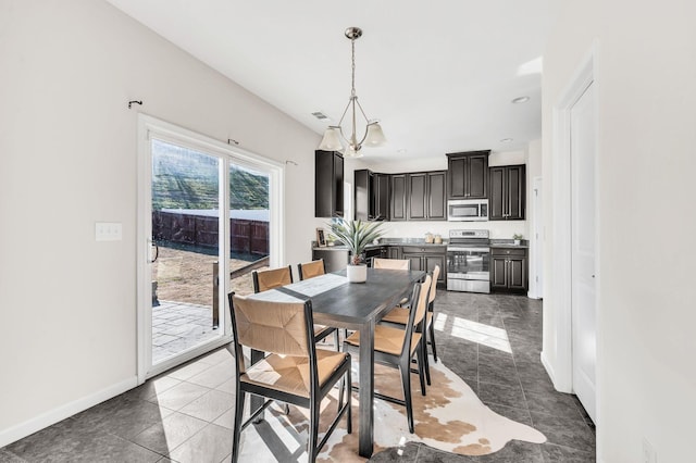 tiled dining room featuring a notable chandelier